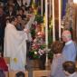 DSC_0243 Archpriest placing flowers at foot of image of Bambina