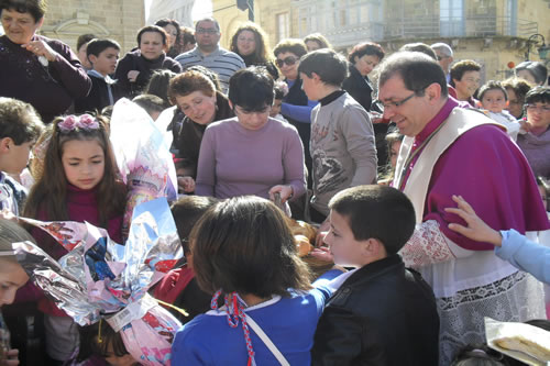 39 Distributing Easter Buns to children