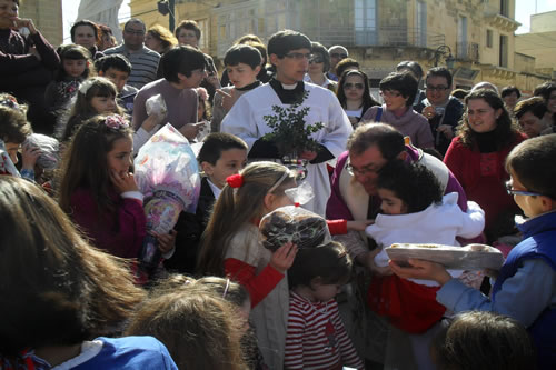 35 Distributing Easter Buns to children