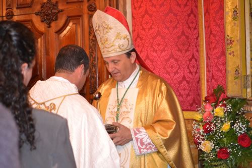 DSC_0132 Bishop handing him Holy Water