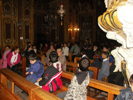 B1 Children follow the proceedings near main door