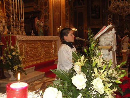 G3 Young altar boy recites prayers during adoration