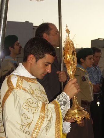 G8 Deacon Anthony Bajada with the Blessed Sacrament in hand