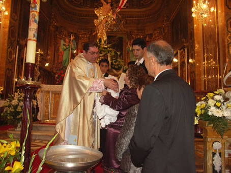 C7 Anointing baby's ears with the sacred oil